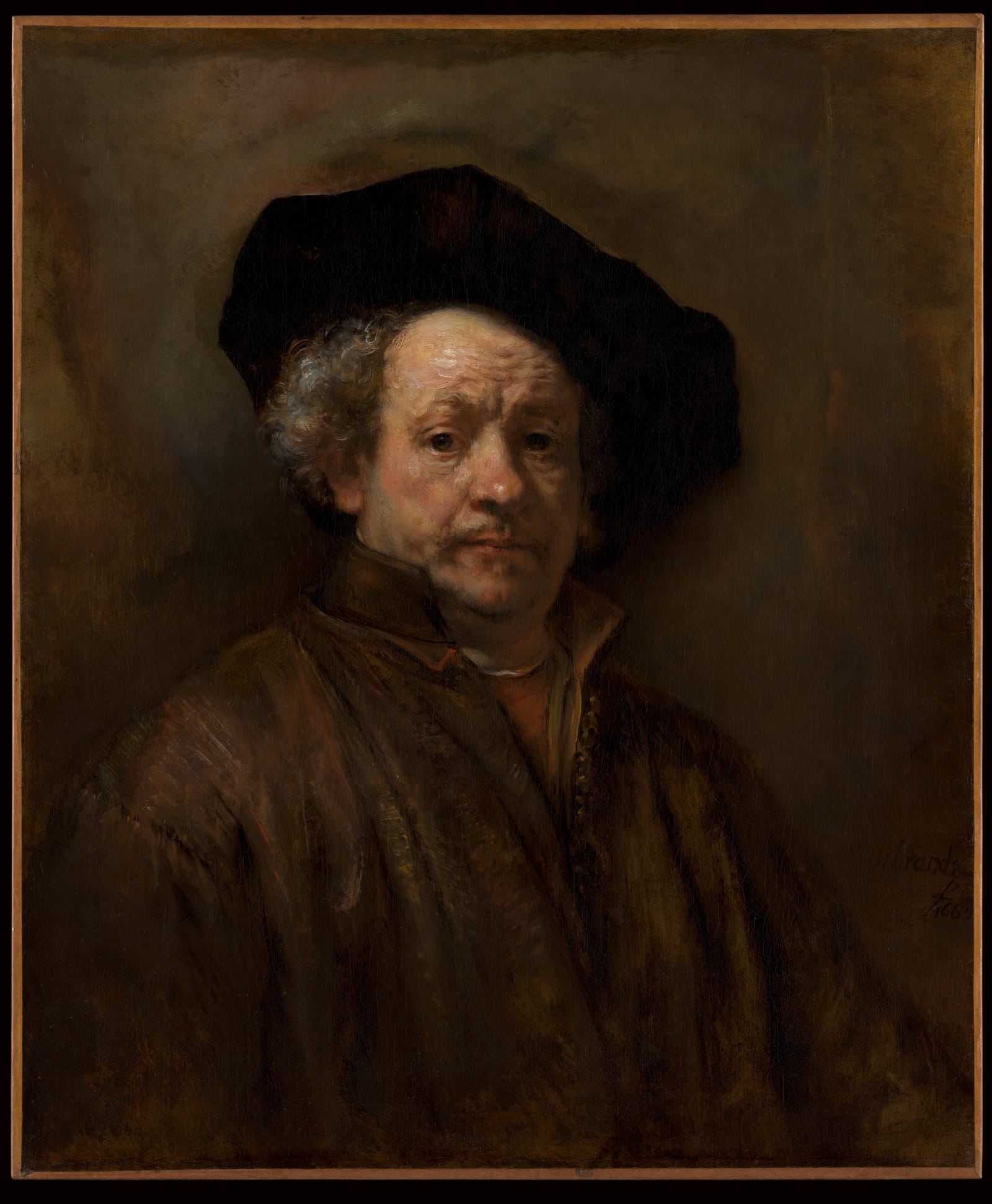 Rembrandt in a dark coat and cap, lit from the left, looking out of deep shadow.